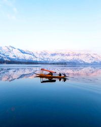 Scenic view of shikara in lake against sky. 