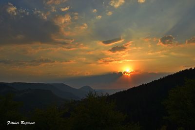 Scenic view of mountains against sky at sunset