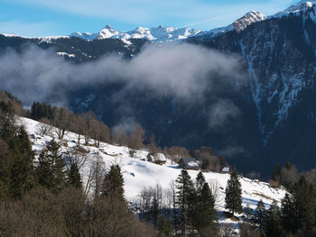 Scenic view of snow covered mountains against sky