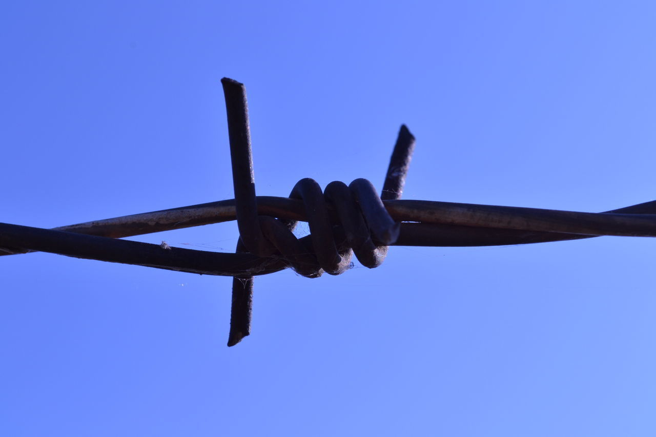 LOW ANGLE VIEW OF FENCE AGAINST BLUE SKY
