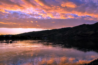 Scenic view of lake against orange sky