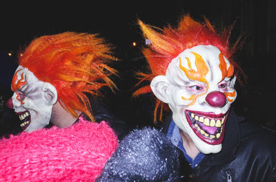 Men in clown mask at night