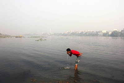 Boy standing in water