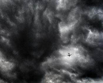 Low angle view of airplane flying in sky