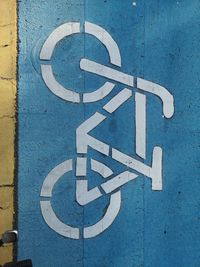 Close-up of arrow sign on wall