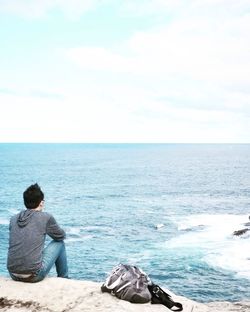 Rear view of man looking at sea