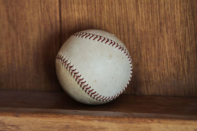 Close-up of baseball on wooden shelf