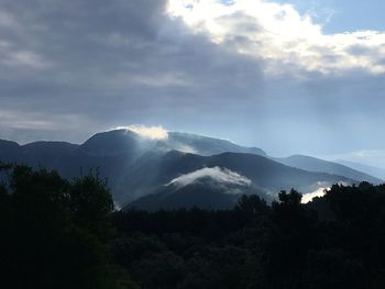 Scenic view of silhouette mountains against sky