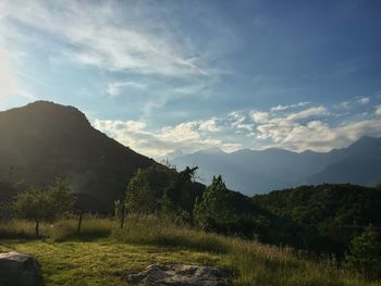 Scenic view of mountains against cloudy sky