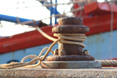 Close-up of rope on bollard against sea