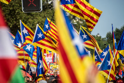 Low angle view of catalan estelada flags against blue sky