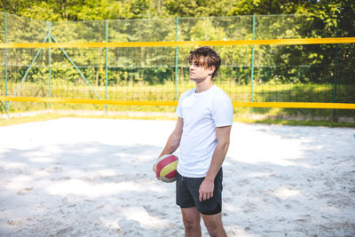 Full length of young man standing on field