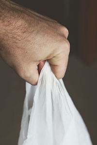 Close-up of hand holding hands against black background