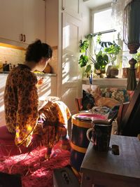 Woman sitting on table at home