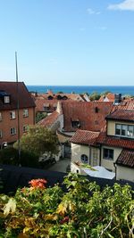 Houses in city against clear blue sky