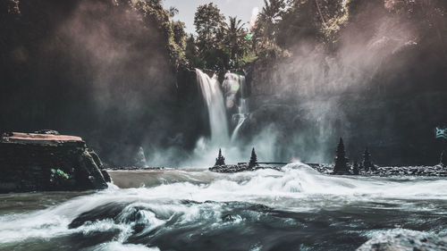 Scenic view of waterfall in sea