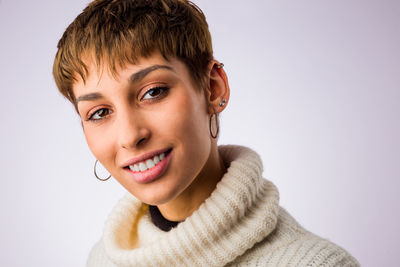 Portrait of young woman against white background