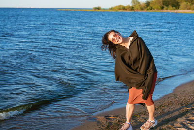 Portrait happy smiling woman on beach. smiling sensual brunette posing