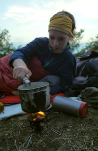 Midsection of man sitting on barbecue grill