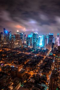 Aerial view of city lit up at night