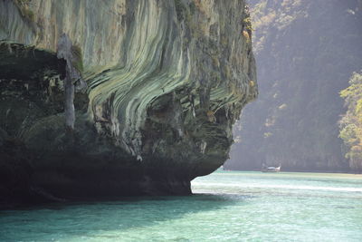 Scenic view of sea by cave