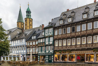 Low angle view of buildings against cloudy sky