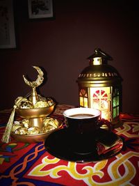 Close-up of illuminated tea light candles on table