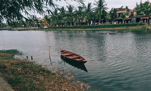 Boats in canal along buildings