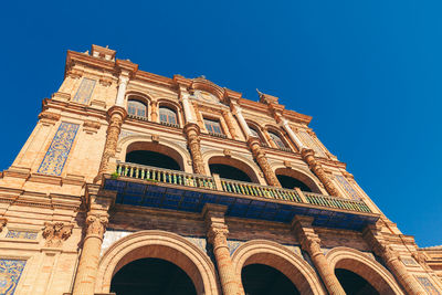 Low angle view of historical building against blue sky