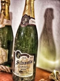 Close-up of wine glass with bottles