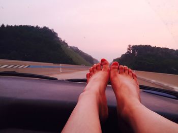 Cropped image of woman looking through train window