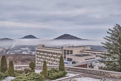 High angle view of buildings and mountains against sky