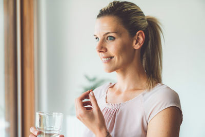 Young woman drinking glass