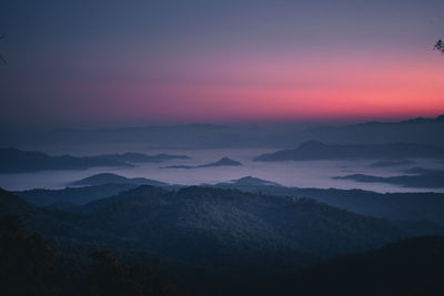 Scenic view of silhouette mountains against sky during sunset