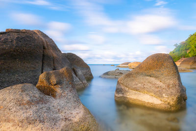 Close-up of rocks on shore against sky