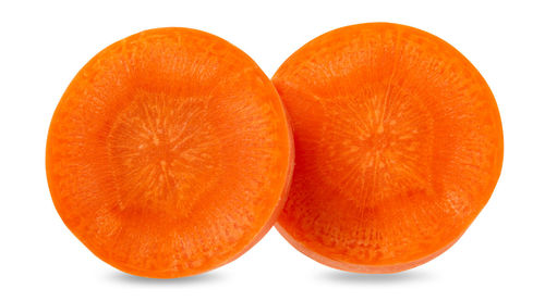 Close-up of orange slices over white background