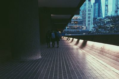 People walking on illuminated street