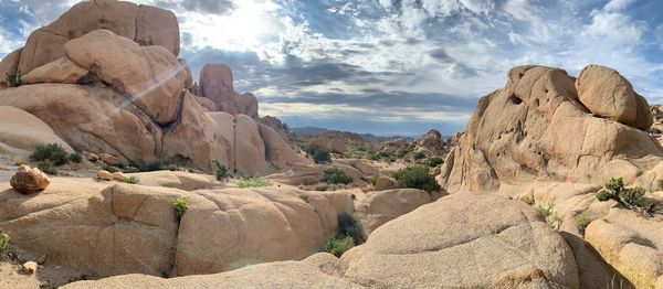 Panoramic view of rocks and mountains against sky