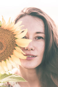 Close-up portrait of beautiful woman against blue sky