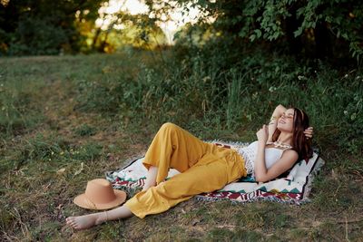 Portrait of woman sitting on field