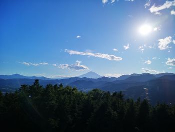 Scenic view of mountains against blue sky