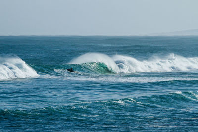 Scenic view of sea waves against sky