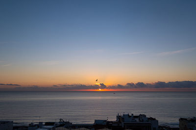 Scenic view of sea against sky during sunrise 