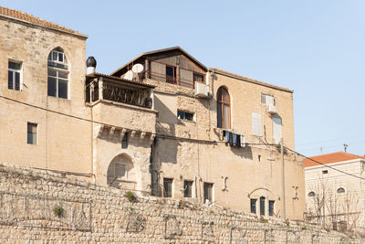 Low angle view of building against clear blue sky