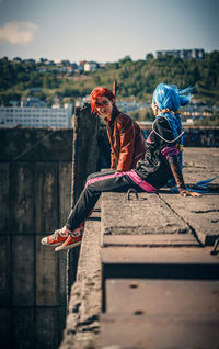 Rear view of woman walking on boardwalk