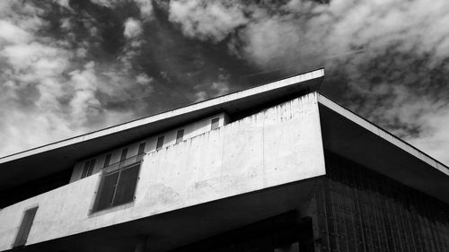 Low angle view of building against cloudy sky