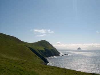 Scenic view of sea and mountains against sky