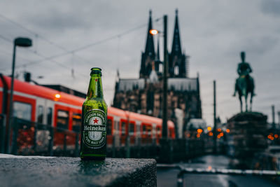 Close-up of bottles on city at dusk