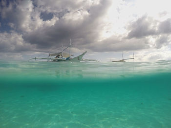 Sailboat in sea against sky