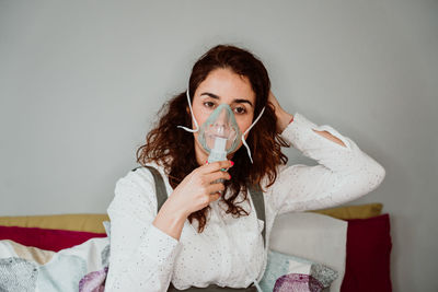 Portrait of young woman drinking glasses